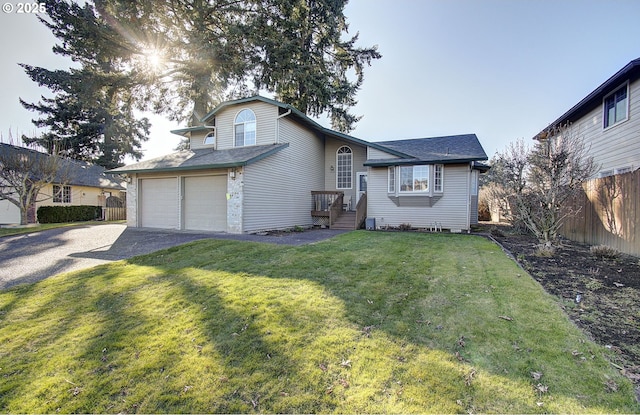 view of front of property with a garage and a front lawn