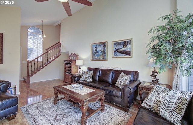 living room featuring wood-type flooring, high vaulted ceiling, and ceiling fan