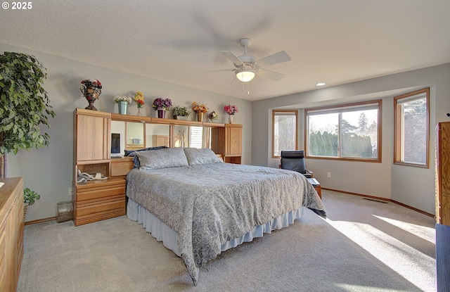 bedroom featuring ceiling fan and light colored carpet