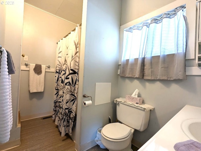 bathroom featuring toilet, hardwood / wood-style flooring, and vanity