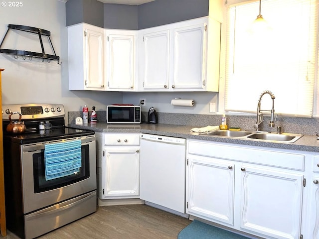 kitchen with sink, stainless steel electric range oven, white cabinets, and white dishwasher