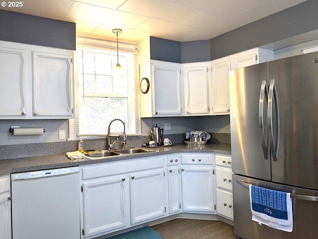 kitchen featuring white cabinets, stainless steel fridge, and white dishwasher