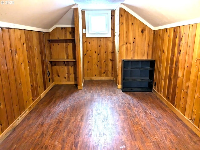 additional living space with lofted ceiling, wood walls, and dark hardwood / wood-style floors