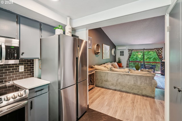 2818 Treetop Ln, West Linn, OR 97068 - kitchen with stainless steel appliances, decorative backsplash, lofted ceiling, wood finished floors, and open floor plan