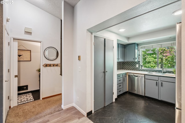 2818 Treetop Ln, West Linn, OR 97068 - kitchen with gray cabinets, appliances with stainless steel finishes, a sink, light countertops, and a textured ceiling