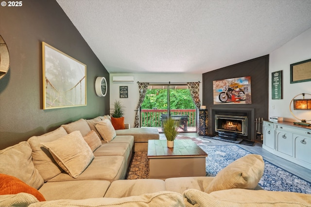 2818 Treetop Ln, West Linn, OR 97068 - living room featuring a textured ceiling, a wall mounted air conditioner, wood finished floors, a lit fireplace, and lofted ceiling