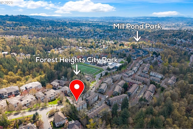 birds eye view of property featuring a view of trees