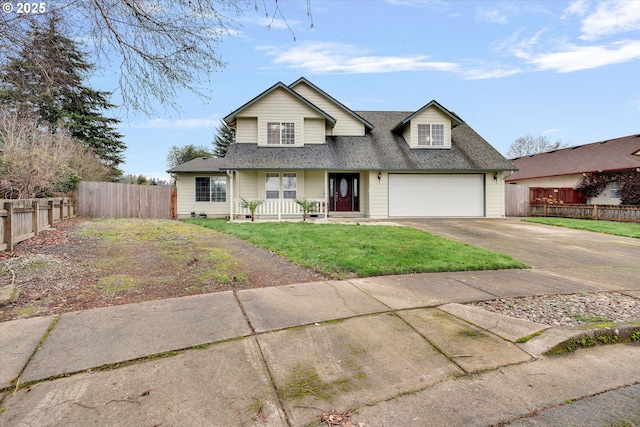 view of front of home featuring a front yard, a garage, and covered porch