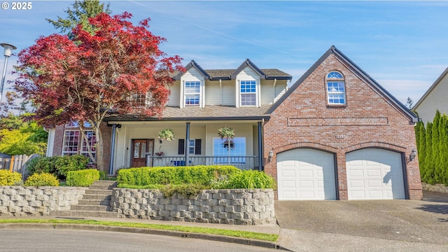 traditional home featuring aphalt driveway, a porch, and brick siding