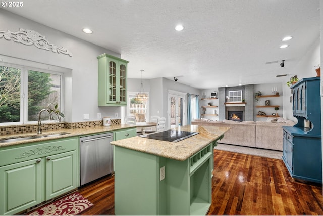 kitchen featuring a sink, green cabinets, stainless steel dishwasher, and black electric stovetop