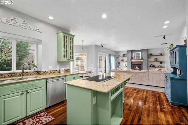 kitchen featuring a sink, green cabinets, black electric stovetop, and stainless steel dishwasher