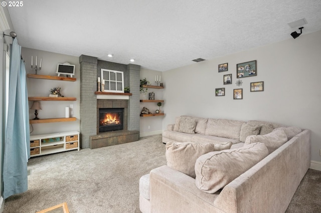 living room with carpet floors, visible vents, a brick fireplace, baseboards, and a textured ceiling