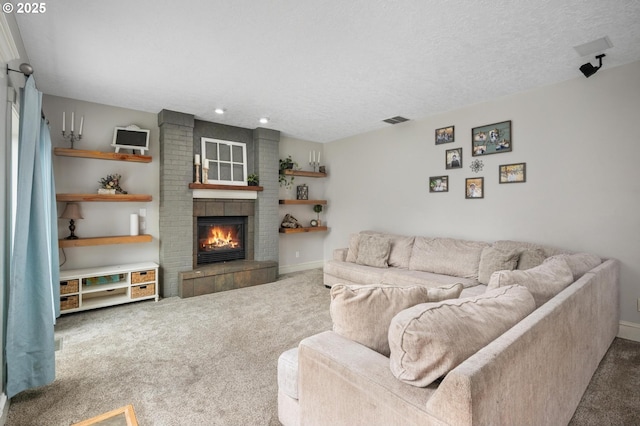 carpeted living area featuring visible vents, baseboards, a textured ceiling, and a brick fireplace