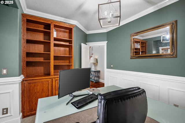 office area with crown molding, a wainscoted wall, and an inviting chandelier
