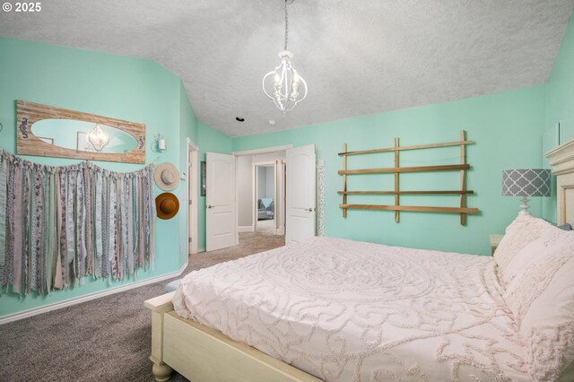 carpeted bedroom with vaulted ceiling, a notable chandelier, baseboards, and a textured ceiling