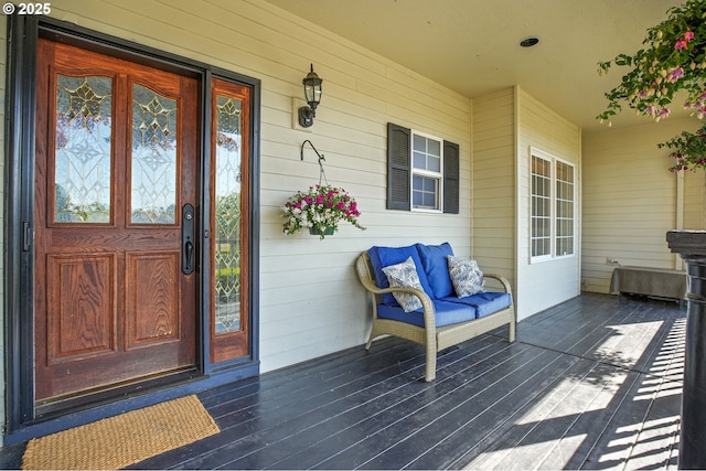 view of exterior entry with a porch