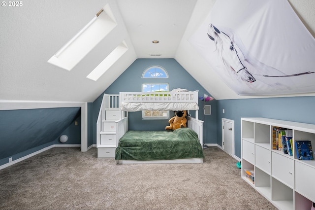 bedroom featuring lofted ceiling with skylight, carpet flooring, baseboards, and visible vents