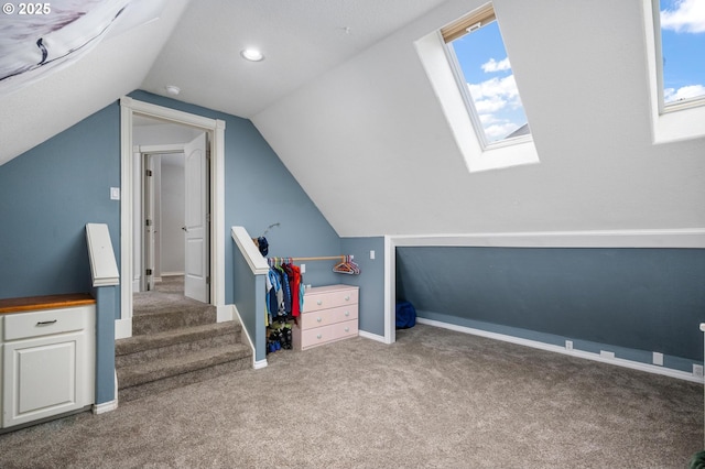 bonus room with lofted ceiling with skylight, plenty of natural light, baseboards, and carpet floors