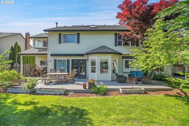 back of property featuring french doors, a lawn, a deck, fence, and outdoor lounge area