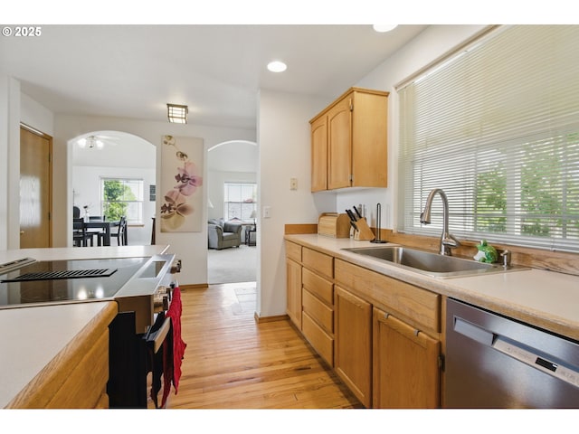 kitchen with electric stove, light wood-type flooring, arched walkways, a sink, and dishwasher