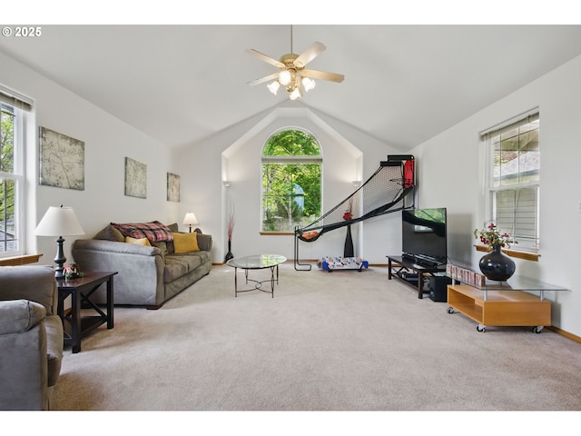 carpeted living area with ceiling fan, baseboards, and lofted ceiling