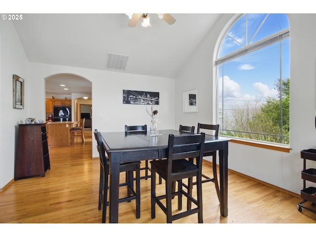 dining space featuring visible vents, arched walkways, a ceiling fan, and a wealth of natural light