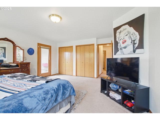 carpeted bedroom featuring multiple closets
