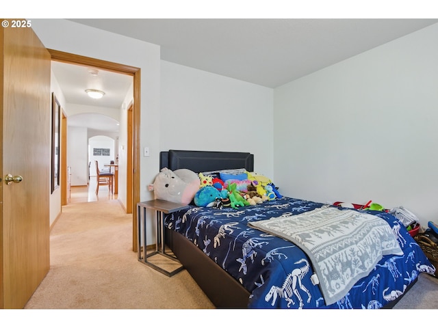 bedroom with carpet flooring and arched walkways