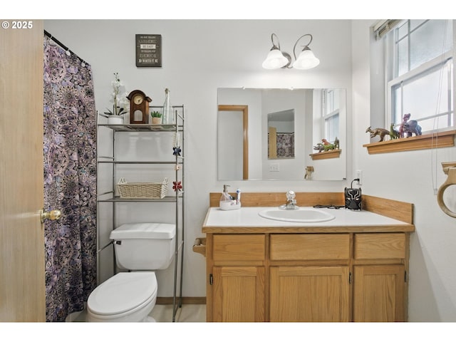 bathroom featuring vanity and toilet