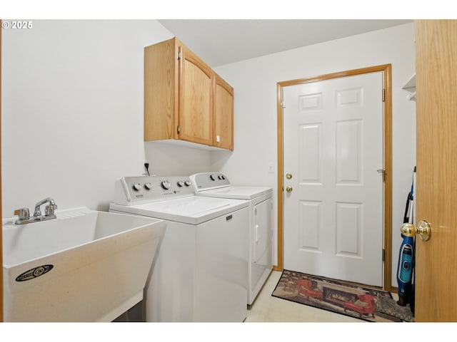 laundry area featuring a sink, cabinet space, and washer and clothes dryer