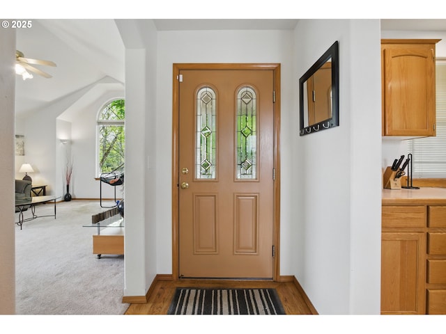 entrance foyer featuring ceiling fan and baseboards