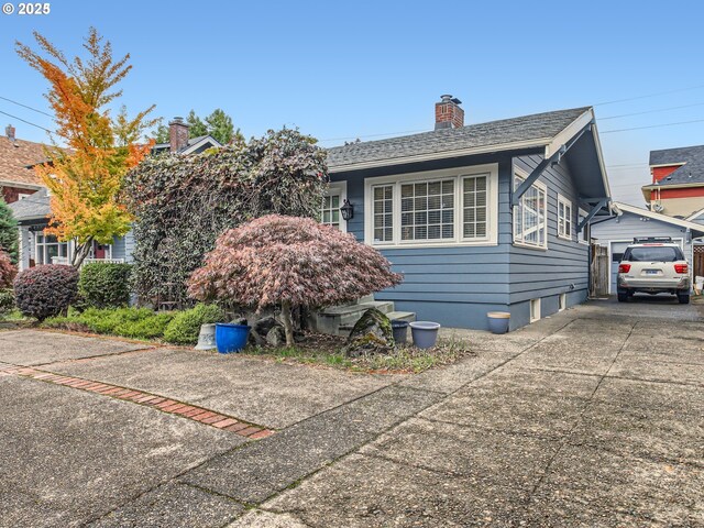 1027 SE Tacoma St, Portland, OR 97202 - view of front facade with a chimney and driveway