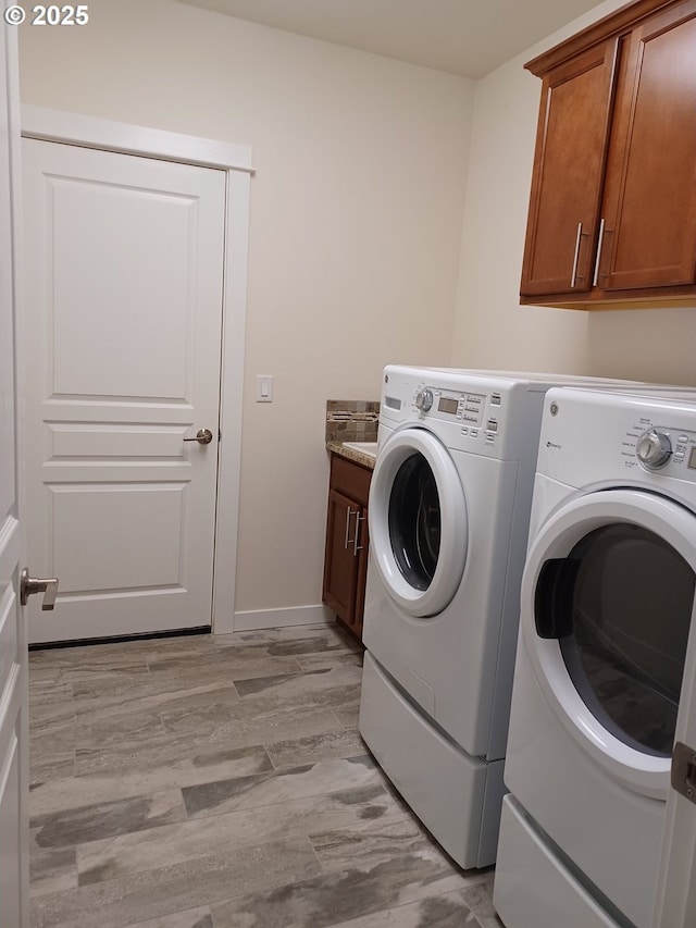 3625 Snowberry Rd, Eugene, OR 97403 - laundry area featuring separate washer and dryer, cabinet space, and light wood-style floors