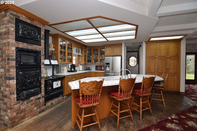 1397 State Route 506, Vader, WA 98593 - kitchen featuring stainless steel fridge, dark wood finished floors, light countertops, glass insert cabinets, and brown cabinetry