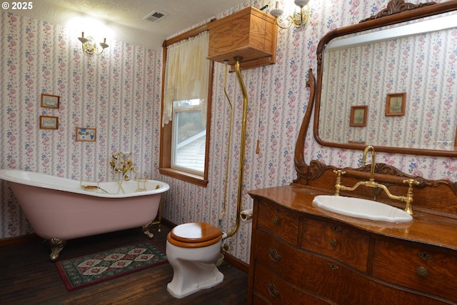 1397 State Route 506, Vader, WA 98593 - bathroom featuring wood finished floors, vanity, a soaking tub, and wallpapered walls