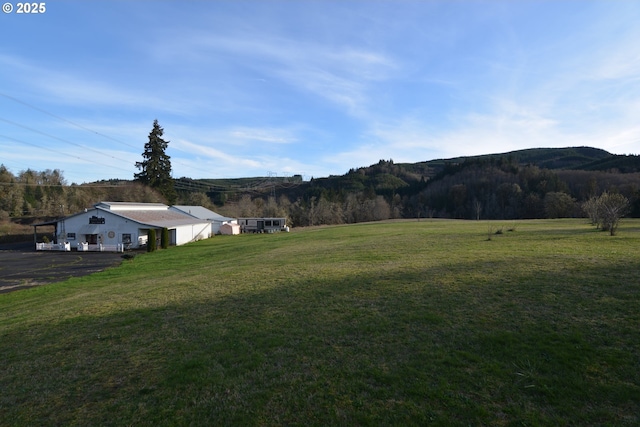 1397 State Route 506, Vader, WA 98593 - view of grassy yard with a mountain view, a view of countryside, an outbuilding, and a forest view