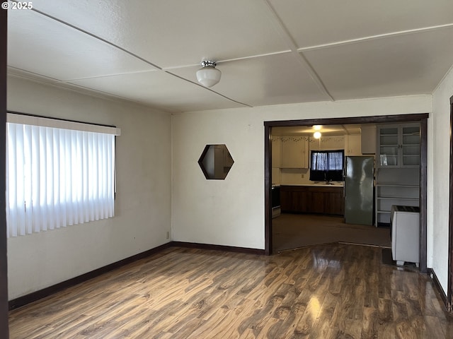 unfurnished room featuring dark hardwood / wood-style flooring