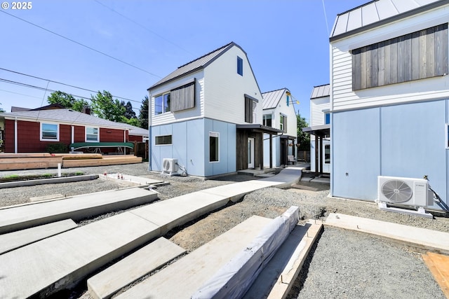 45 W 27th Ave Unit B, Eugene, OR 97405 - rear view of property with a cooling unit, a standing seam roof, metal roof, and a vegetable garden
