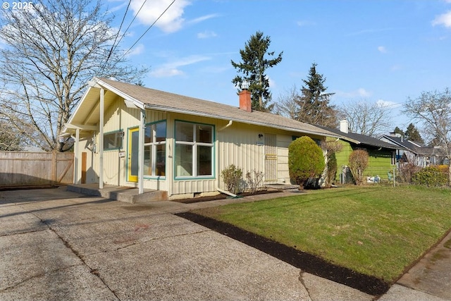 rear view of house with a lawn