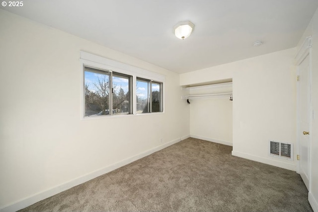 unfurnished bedroom featuring carpet floors and a closet