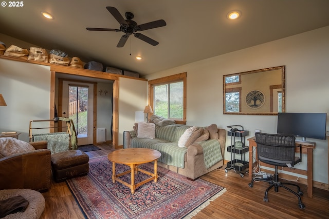 living room featuring hardwood / wood-style flooring, ceiling fan, and vaulted ceiling