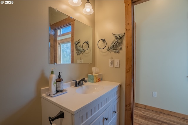 bathroom with hardwood / wood-style flooring and vanity