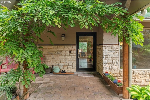 property entrance featuring stone siding