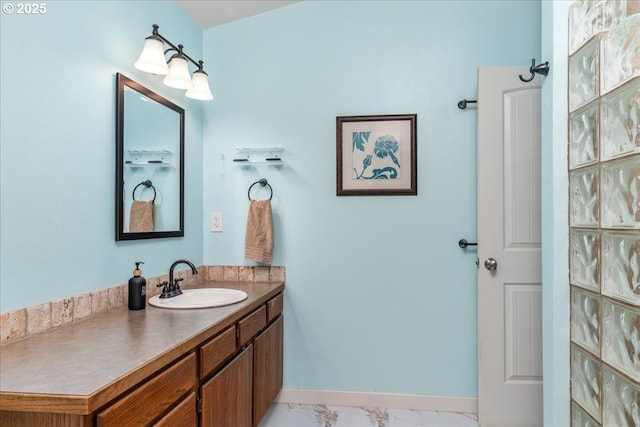 bathroom with vanity and marble finish floors