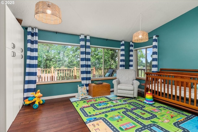 bedroom featuring wood finished floors and baseboards