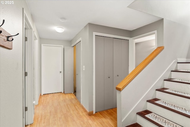 hall featuring light wood-type flooring and stairway
