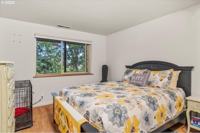 bedroom with wood finished floors and baseboards
