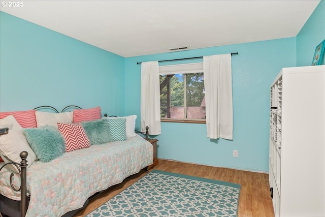 bedroom with wood finished floors