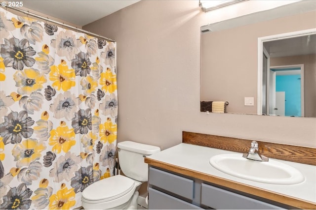bathroom featuring vanity, toilet, and a shower with shower curtain