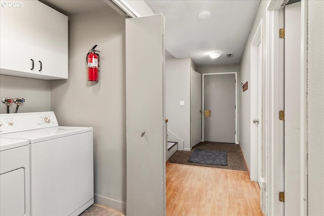 washroom with separate washer and dryer and light wood finished floors